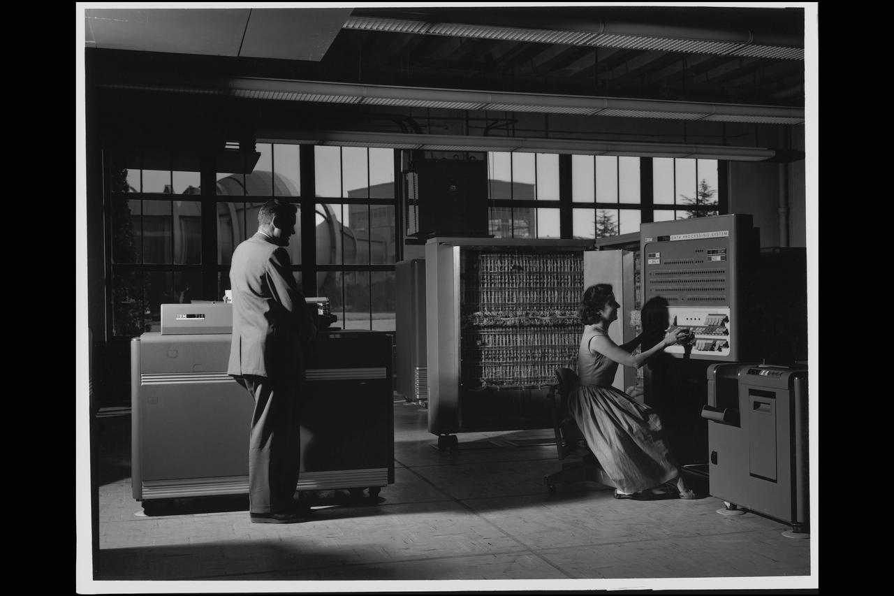Electronic Machine Computing Branch, 704 computing lab; (left - right) William A Mersman and Marcelline K Chartz (aka -  Marcie Smith) with IBM 704 Date Processor