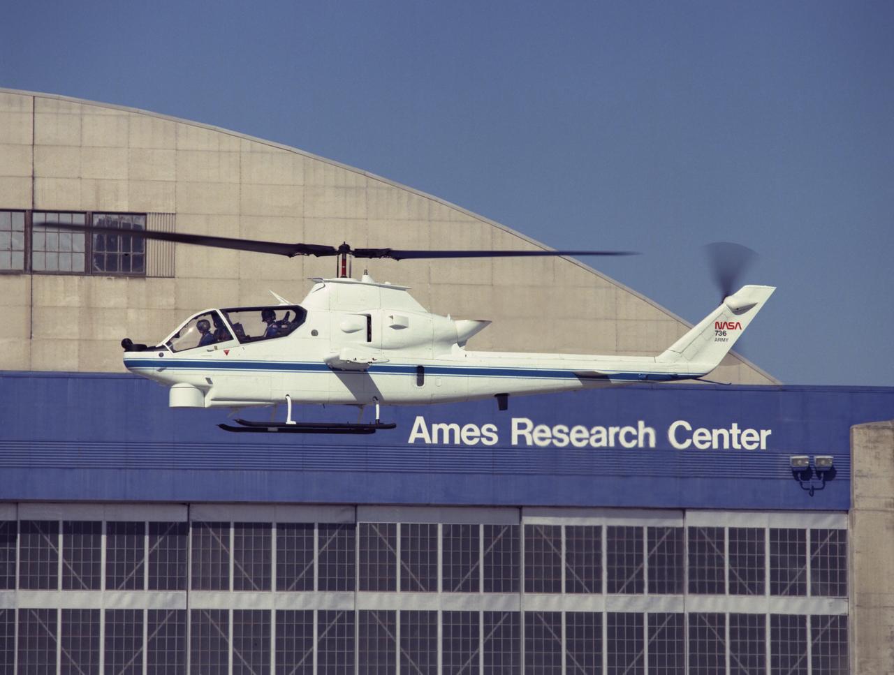 Bell NAH-1G (USA  70-15979 NASA-736) FLITE Cobra helicopter hovering on Ames ramp is successor to the original FLITE Cobra. It has been used extensively in joint NASA/Army human factors research in the areas of night vision displays and voice communications since its arrival in 1987. Note:  Used in publication in Flight Research at Ames;  57 Years of Development and Validation of Aeronautical Technology NASA SP-1998-3300 fig 140
