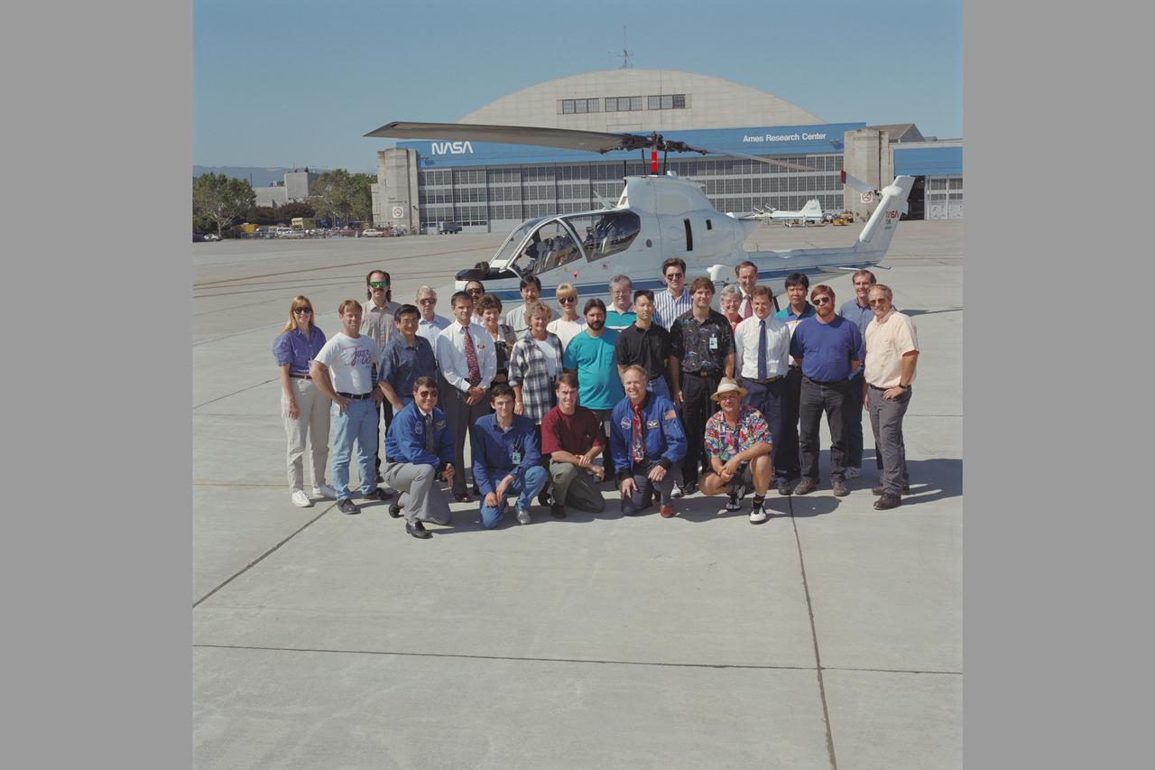 FIELD OF VIEW OVERLAP STUDY PROJECT TEST ON FLIGHT LINE WITH NASA 736 COBRA (USA 70-15979). FLITE Cobra Research Team  Personnel - Front row, L-R:  Tom Reynolds, Nick Pirot, Sean Hogan, Loran Haworth, John Browning.  Middle row, L-R:  Dr. Mary Kaiser, John Spooner, Richard Lee, Montoe Deering, Sue Laurie, Paul Aristo, Alan Lee, Zsolt Halmos, Zoltan Szoboszlay, John Denman, Lee Mountz.  Back row, L-R:  Dr. Dave Foyle, Millard Edgerton, Ron Fong, Gertrude 'Trude' Schlaich, Gary Leong, Linda Blyskal, Brian Hookland, Steve Timmons, Fran Kaster, Wendel Stephens, Alex Macalma, Dana Marcell.  Fig. 141  NASA SP Flight Research at Ames: 57 Years of Development and Validation of Aeronautical Technology