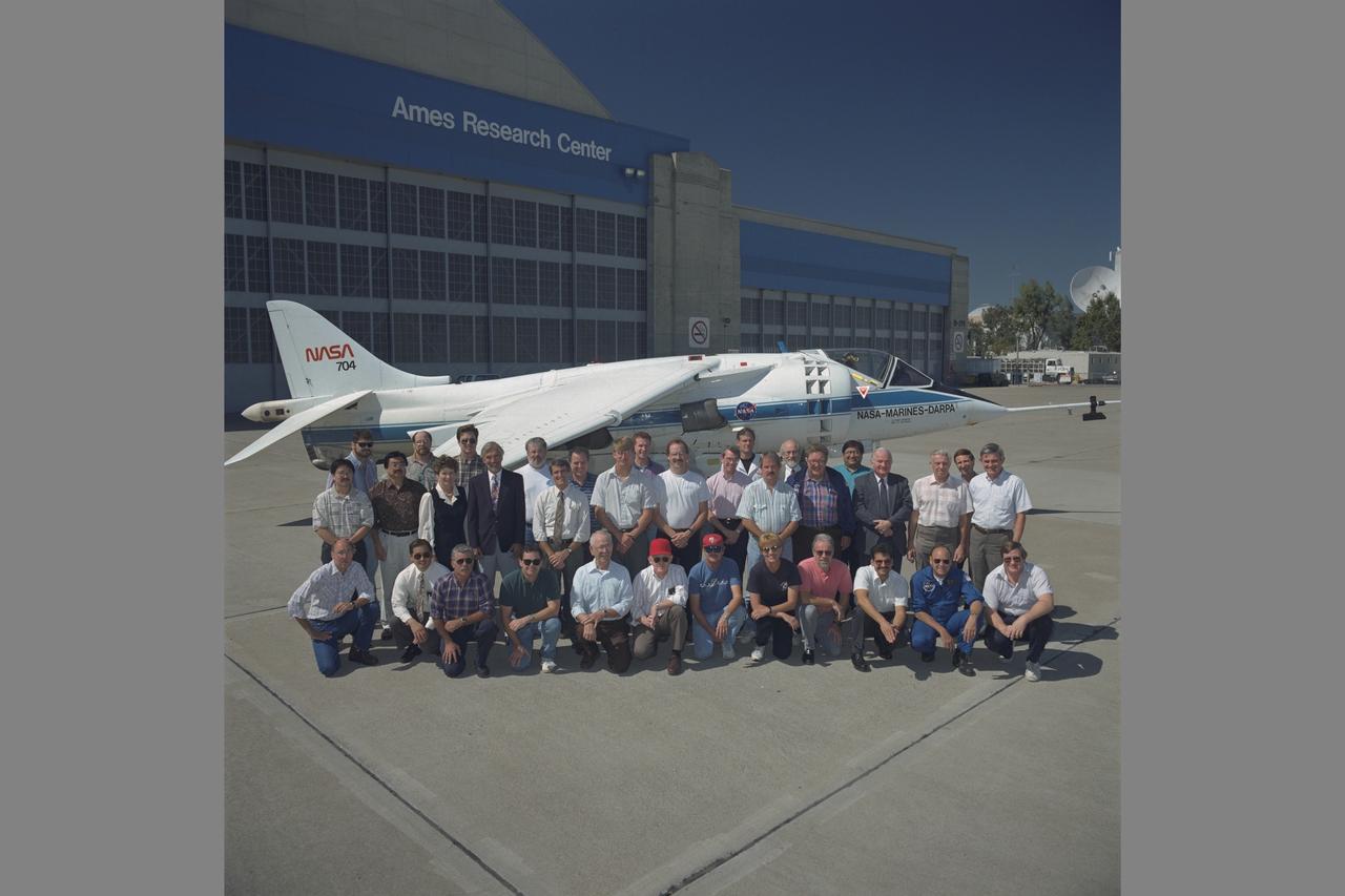 Hart ROTORCRAFT AND POWERED LIFT BRANCH PERSONNEL (CODE AFR) N-211 WITH HARRIER.  VSRA RESEARCH TEAM - Front row, L-R:  Dave Walton, Seth Kurasaki, Bill Laurie, Jim Ahlman, Nels Watz, Del mWatson, Terry Stoeffler, Linda Blyskal, Ed Hess, Manuel Irizarry, Mike Stortz, Bruce Gallmeyer.  Second row, L-R:  Dave Nishikawa, Stan Uyeda, Trudy Schlaich, Tom Kaisersatt, John Foster, Nick Rediess, Kent Shiffer, Paul Borchers, Mike Casey, Sterling Smith, Charlie Hynes, Vern Merrick, Jack Franklin.  Back row, L-R:  Thad Frazier, Eric Weirshauser, Steve Timmons, Brian Hookland, Joe Paz, Kent Christensen, Jack Trapp, Bill Bjorkman, Ernesto Moralez, Joe Konecni.  Note:  Used in publication in Flight Research at Ames;  57 Years of Development and Validation of Aeronautical Technology NASA SP-1998-3300 fig. 126