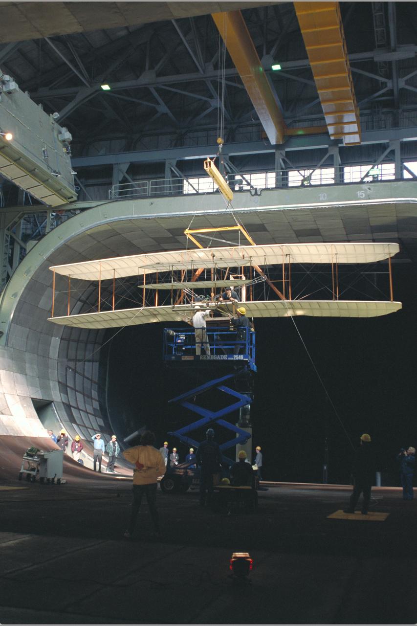 View of Installation with Pete Zell (In Cap) and Felton Smith and Richard McLimoil (In Shadows).  Wright Flyer Replica Test-40-0047:  40 x 80 ft. Wind Tunnel.