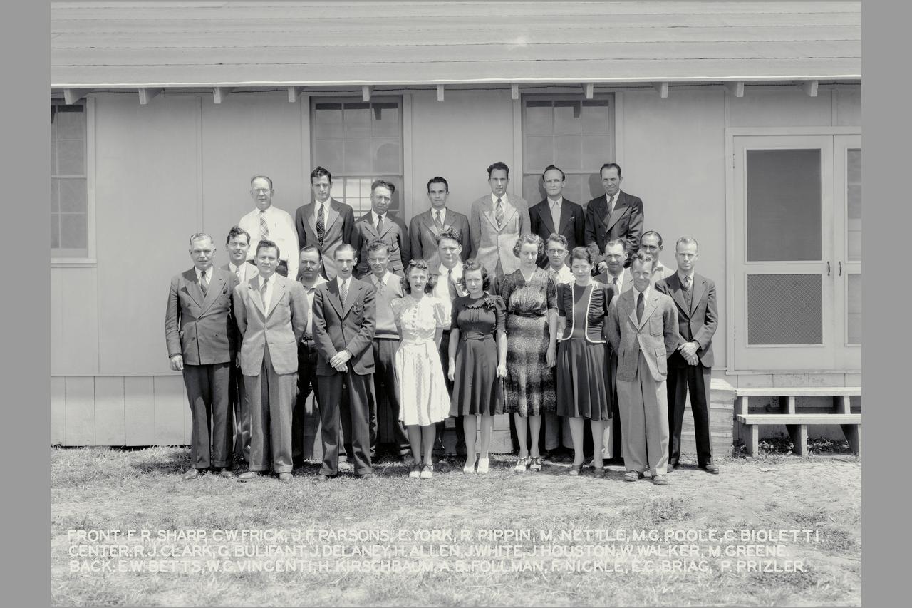 Ames Personnel  in front of construction shack FRONT: ER Sharp, CF Frick, JF Parsons, E York, R Pippin, M Nettle, M G Poole, C Bioletti  CENTER: R Clark, G Bulifant, J Delaney H. Allen, J. White, H. Houston, W. Walker, M. Green BACK: E. W. Betts. W.G.. Vincenti, H Kirschbaum, A.B. Follman, F. Nickle, E.C.. Briag, P. Prizler