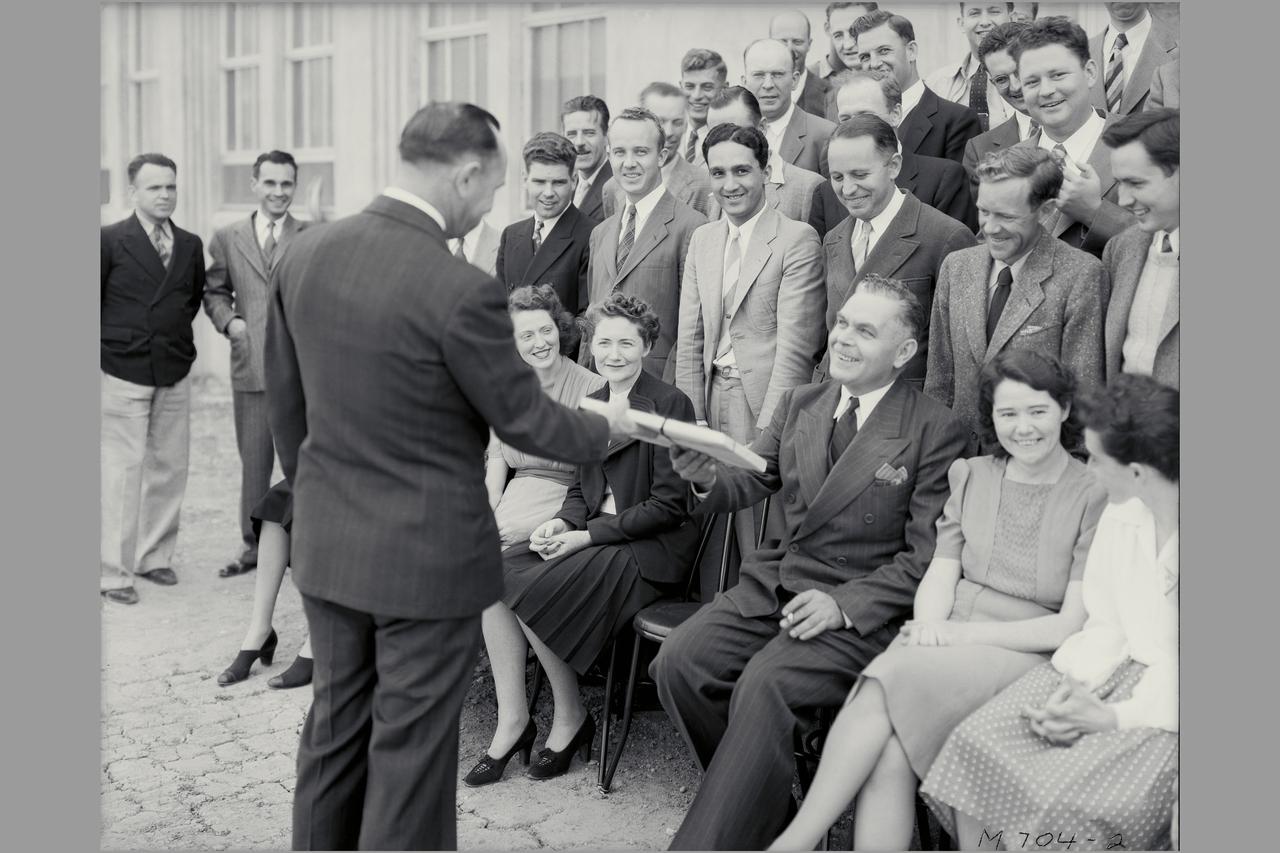 Dr Smitty DeFrance greets Ames original staff members as they prepare to have photo taken