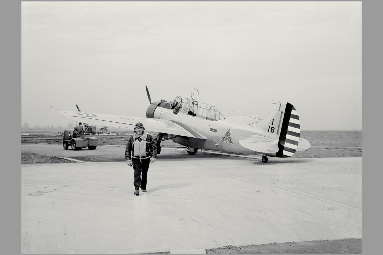 A new three-place North American O-47A observation airplane with Army Air Corps marking was the first ircraft to arrive at Ames. The Circular antenna on top of the canopy is for direction finding. A close look show that help from the front cockpit was needed for directional control when using a rope (instead of a tow bar) to tow the aircraft. (Sept 1940). W.H. McAvoy Ames test pilot returning from an early flight of first test airplane at Ames, a North American O-47A-1 (or 0-47 AAC37-323) This aircraft severed for a short time upon arrival as a research aircraft for heated-wing deicing. NOTE: printed in NASA Ames Publications: Adventures in Research - SP-4320 57 Years - Flight Research at AMES - NASA SP-1998-3300