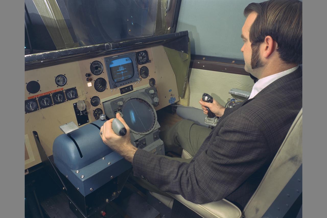 PILOT KENNETH C. WHITE IN CHAIR.  Space Shuttle Vehicle Simulation. SSV COCKPIT IN THE MOVING-CAB TRANSPORT SIMULATOR (S.16)