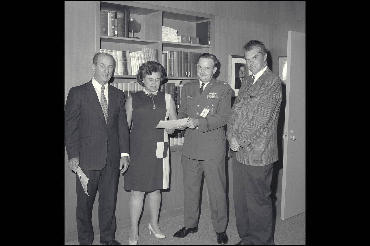 Air Force office personnel (L-R) Tusch, Davis, Trammell  with Dr. Hans Mark, Ames Director