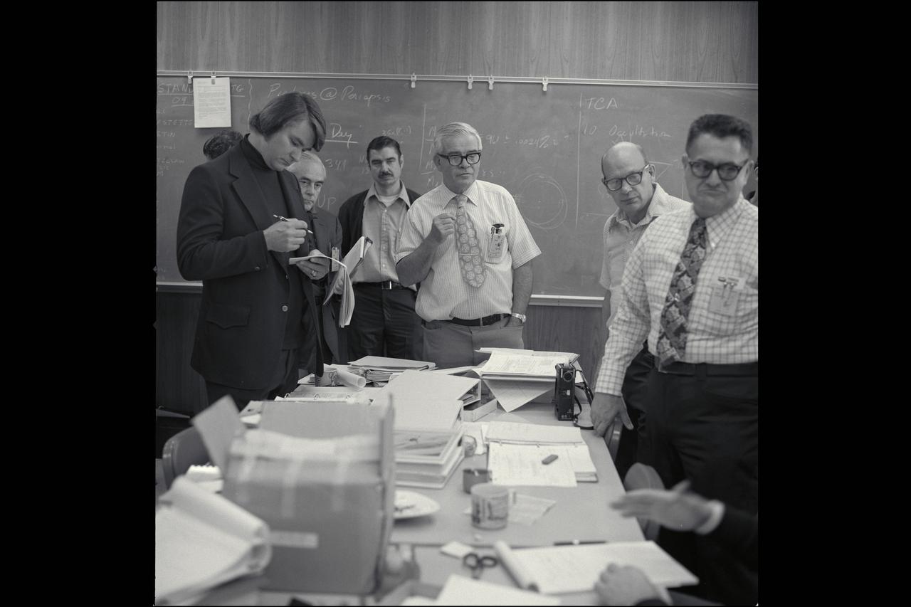 Pioneer 10; Mission to Jupiter Project Manager Charlie Hall (center) leads the Pioneer staff through his efficient (and infamous) stand-up meeting  (also shown (L-foreground) Skip Nunamaker and (R-foreground) Richard Fimmel