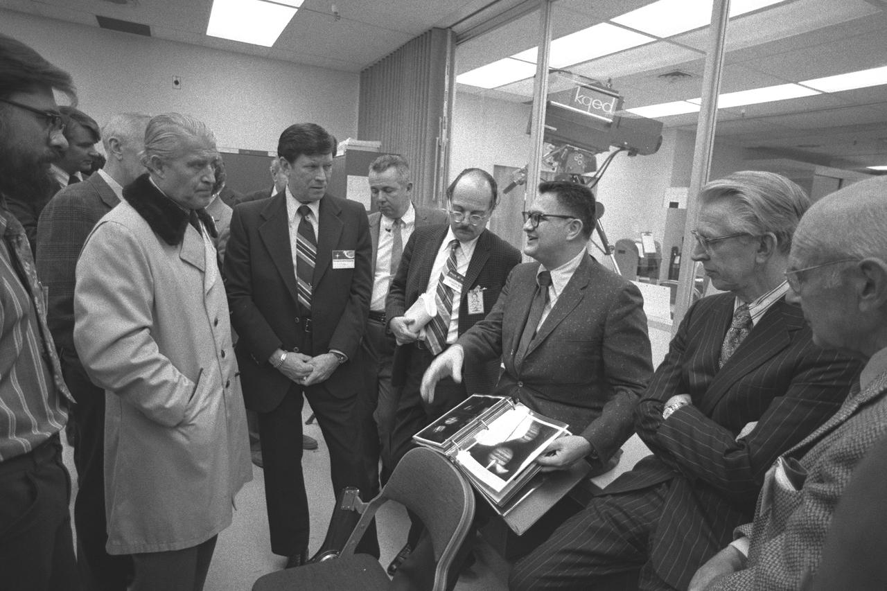 Pioneer 10 Mission to Jupiter; Press conference and tour of Mission Control for VIP visitors with Dr. Werner Von Braun on left (in trench coat) Dr Richard Fimmel, Ames, center (with album) and Dr Fletcher, NASA Administrator to his right.