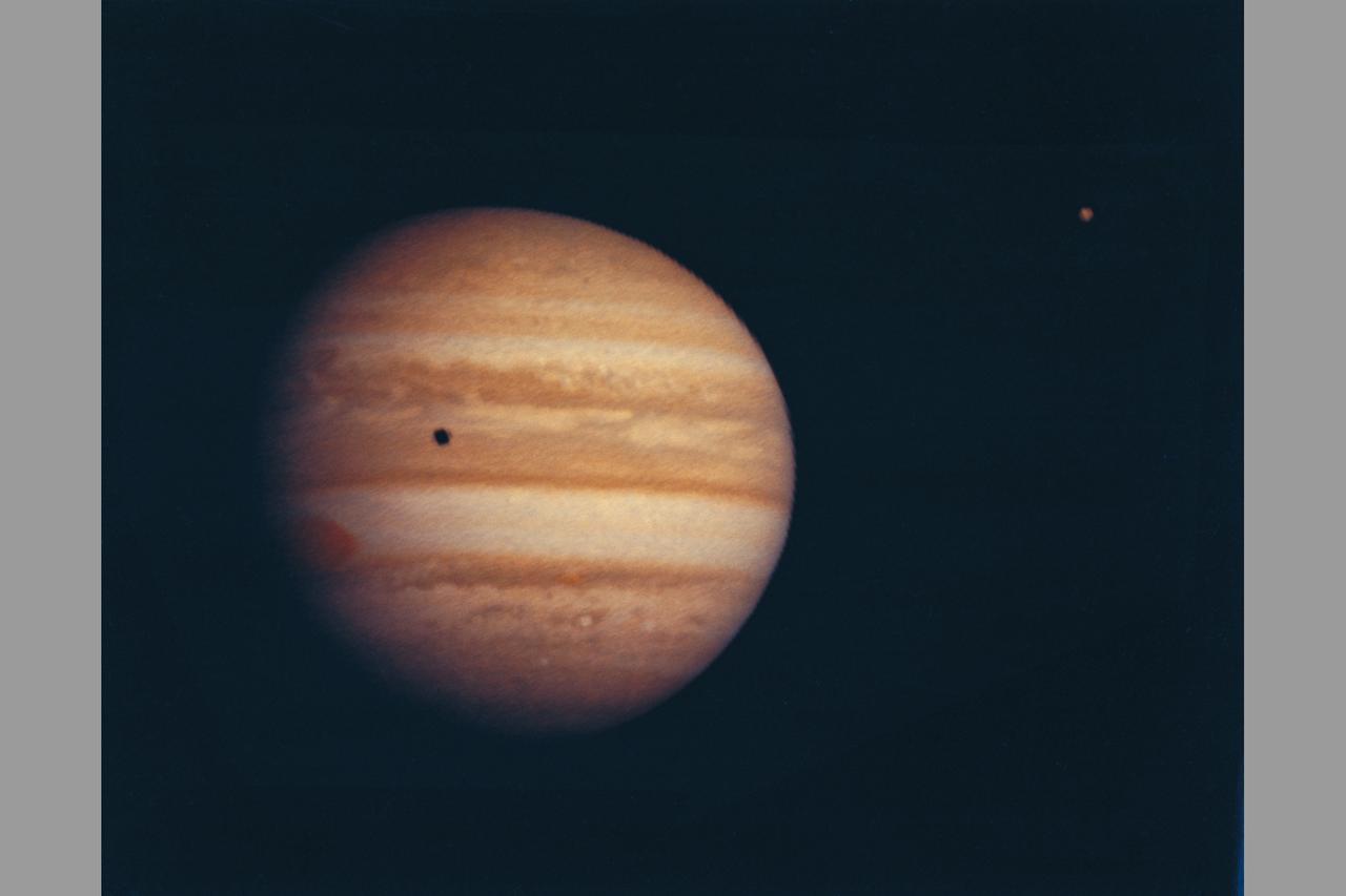Photograph by Pioneer 10   Jupiter at a range of 2584000km (ref: image number sequence A-51 (before) during the 4 days on either side of closest approach) moon seen on upper right on image.