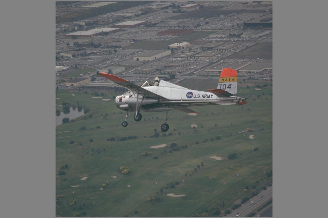 X-14B NASA-704: A Bell single-place, open cockpit, twin-engine, jet-lift VTOL aircraft in flight over Sunnyvale golf course. The X-14 was used by NASA Ames Research Center to advance state-of-the-art jet-powered VTOL aircraft.