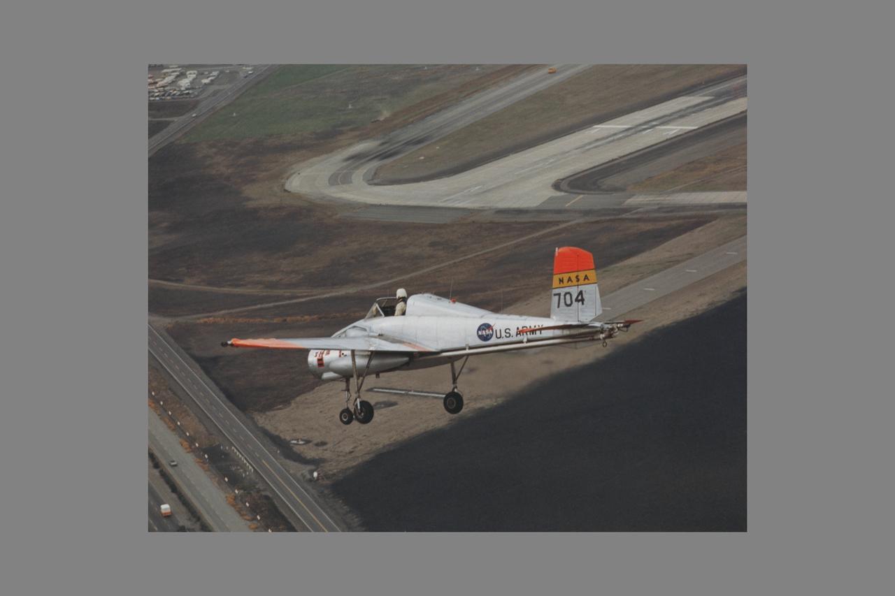 X-14B NASA-704: A Bell single-place, open cockpit, twin-engine, jet-lift VTOL aircraft over Highway 101 in approach to Moffett Field, California. The X-14 was used by NASA Ames Research Center to advance state-of-the-art jet-powered VTOL aircraft.