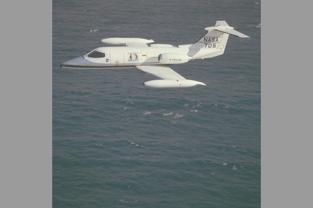 Lear Jet 24B  (NASA-705) in flight along California coast is used primarily as a high altitude observation platform carrying a 12' telescope with a special hatch on the starboard side for upward viewing. The hatch has a maximum circular clear aperture of 37.6 cm and can contain a 30 cm aperture open-port gyro-stabilized telescope designed especially for infrared astronomical research.