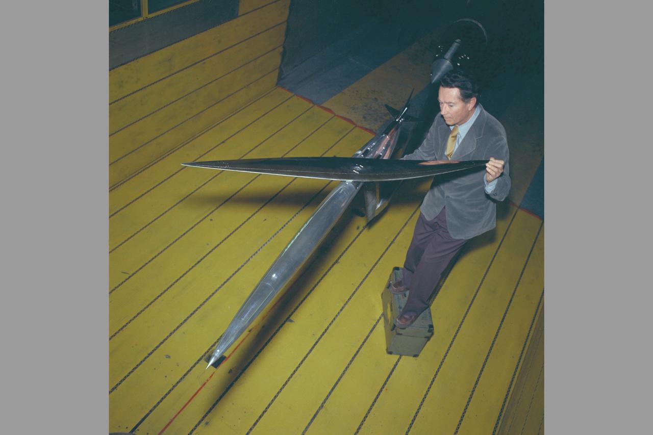 Oblique Wing model mounted in 11ft W. T. with R. T. Jones, Designer/Engineer. The asymmetrical design allows the plane to fly much faster, yet consume the same fuel and generate less noise.