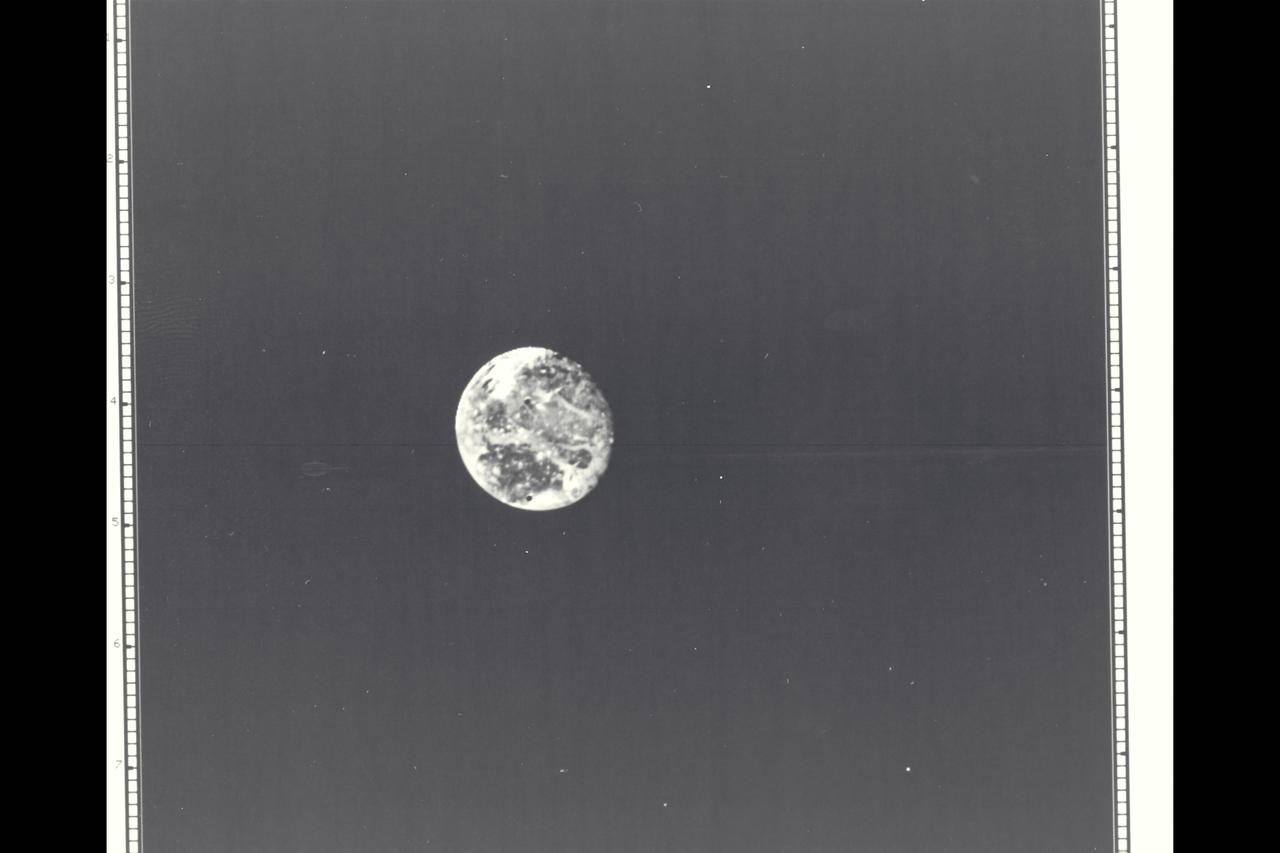 Range : 4.2 million kilometers (2.6 million miles) Ganymede is Jupiter's Largest Galilean satellites and 3rd from the planet. Photo taken after midnight Ganymede is slightly larger than Mercury but much less dense (twice the density of water). Its surface brightness is 4 times of Earth's Moon. Mare regions (dark features) are like the Moon's but have twice the brightness, and believed to be unlikely of rock or lava as the Moon's are. It's north pole seems covered with brighter material and may be water frost. Scattered brighter spots may be related to impact craters or source of fresh ice.