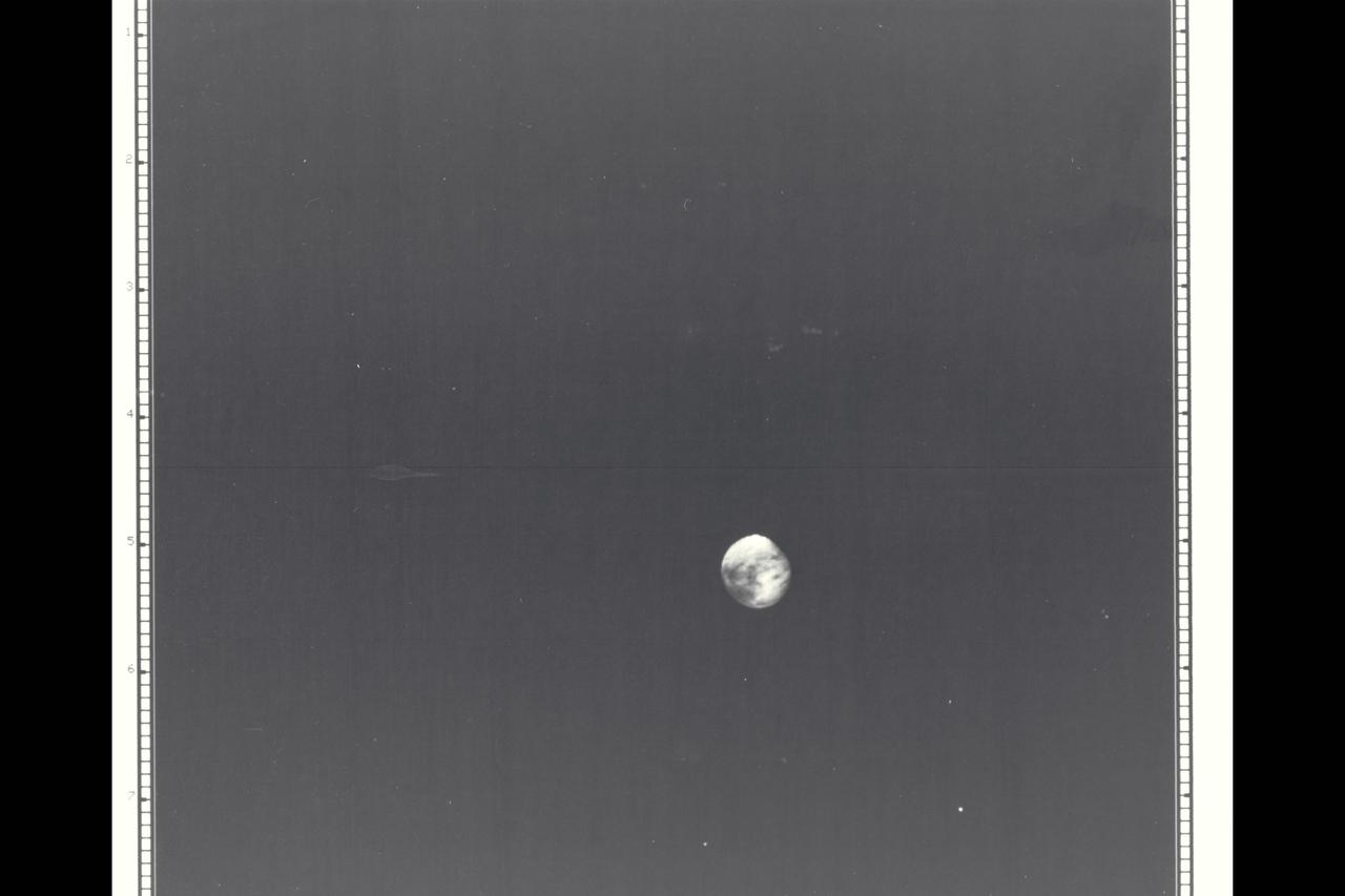 Range : 5.9 million kilometers (3.66 million miles) Europa is Jupiter's 2nd Galilean satellite from the planet.  Photo taken early morning and through a violet filter.  Faint swirls and Linear Patterns show in the equarorial region(which is darker than the poles). The hemisphere shown always faces Jupiter.  North is up.  Europa is the brightest of the Galilian satellites but shows low contrast on this hemisphere. Density and size is similar to Earth's Moon.  Indications of water ice or ground water on surface is shown