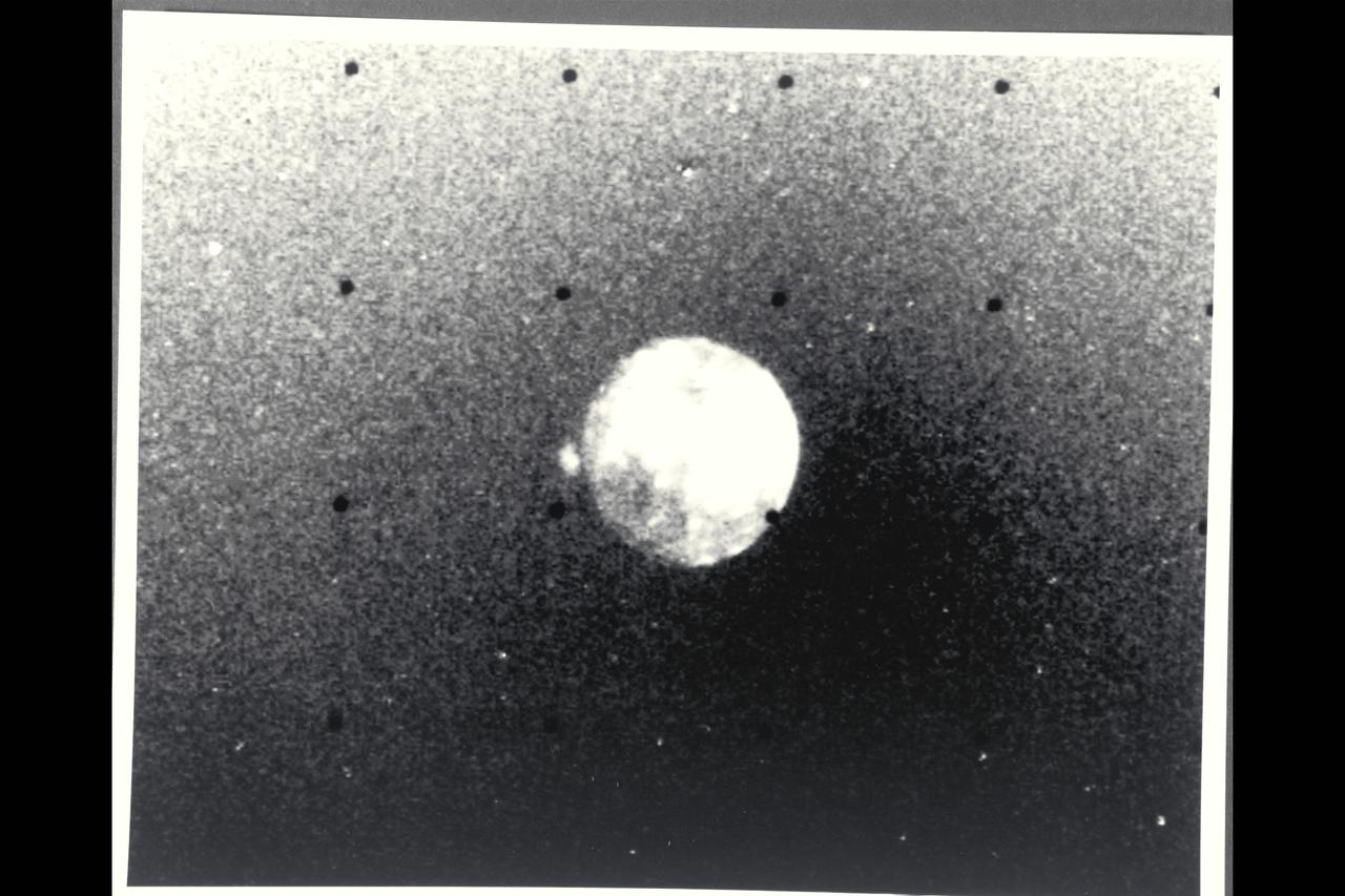 P-21738 BW Raange: 4.76 million kilometers (2.9 million miles) This Voyager 2 picture of Io was taken in ultraviolet light and shows one of the volcanic eruption plumes first photographed by Voyager 1. (the bright spot on the right limb) The plume is more than 200 kilometers (124 miles) high. The volcano apparently has been erupting since it was observed by Voyager 1 in March, 1979. This suggests that the volcanoes on Io probably are in continuous eruption.