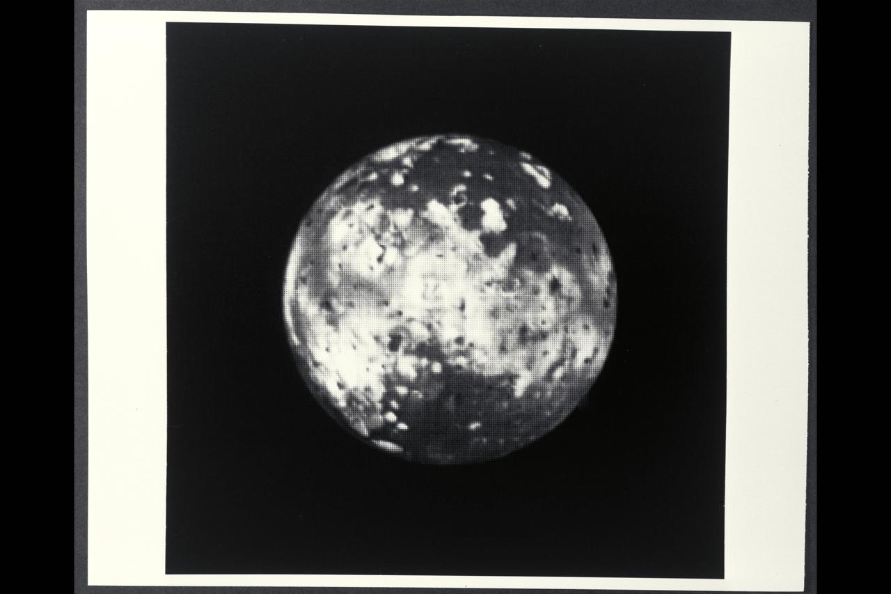 P-21741 BW Range: 2.6 million kilometers (1.6 million miles) This picture of Io, taken by Voyager 1, shows the region of the Jovian moon which will be monitored for volcanic eruptions by Voyager 2 during the 'Io movie' sequence. The white and orange patches probably are deposits of sulphur compounds and other volcanic materials. The Voyager 2 pictures of this region will be much more detailed.