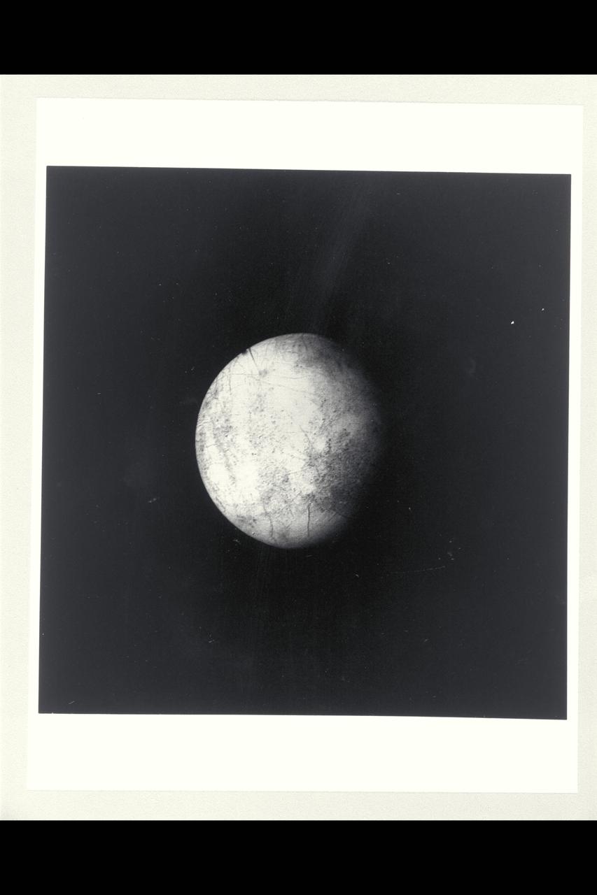 P-21752 BW Range: 1.2 million kilometers This image of Europa shows detail about 20 kilometers across and is somewhat higher resolution than the best Voyager 1 image. The part of Europa shown is the hemisphere that will be viewed at even higher resolution during another Voyager 2 encounter with Europa. Color reconstruction in this image was slightly enhanced to bring out detail in the complicated mottled region on the west limb, containing some of the linear fracture-like features discovered by Voyager 1. The regions in the north and south polar areas which appear bluish in this version are in fact white.