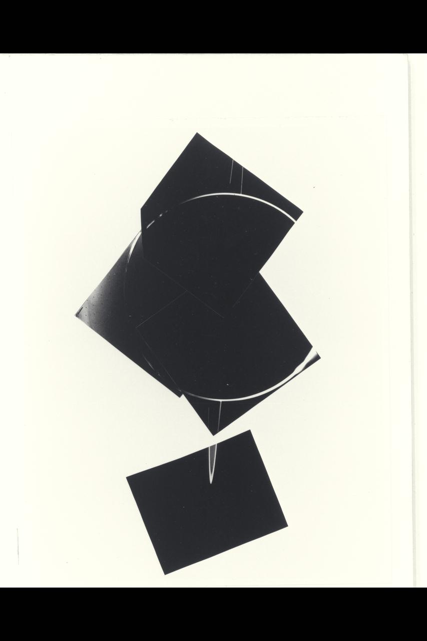 Range :  900,000 miles  A brilliant halo around Jupiter, the thin ring of particles discovered by Voyager 1 four months ago, is seen here unusually bright due to forward scattering of the particles within it. Similiarly, the planet is outlined by sunlight scattered toward the spacecraft from a haze layer high in jupiter's atmosphere. The arms of the ring are cut off on each sideby the planet's shadow as they approach the brightly outlined disk. The night side of the planet appears completly dark in this reproduction, but later will be specially reprocessed to search for evidence of lightning sorms and auroras. This 4 image mosaic was obtained  with Voyager 2's wide angle camera.