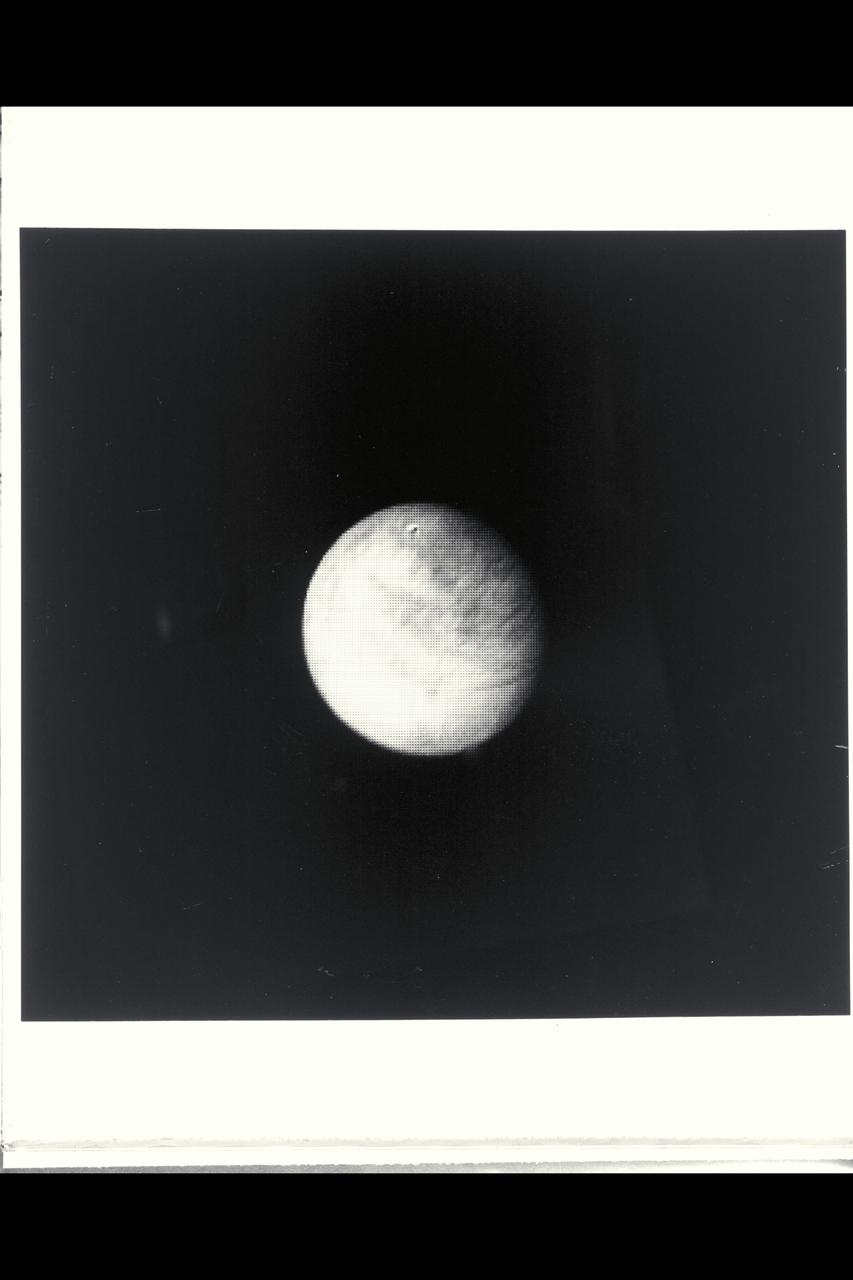 Range :  4.2 million km. ( 2.6 million miles ) Jupiter's moon Europa, the size of earth's moon, is apparently covered by water ice, as indicated by ground spectrometers and its brightness. In this view, global scale dark sreaks discovered by Voyager 1 that criss-cross the the satelite are becoming visible. Bright rayed impact craters, which are abundant on Ganymede and Callisto, would be easily visible at this range, suggesting that Europa's surface is young and that the streaks are reflections of currently active internal dynamic processes.