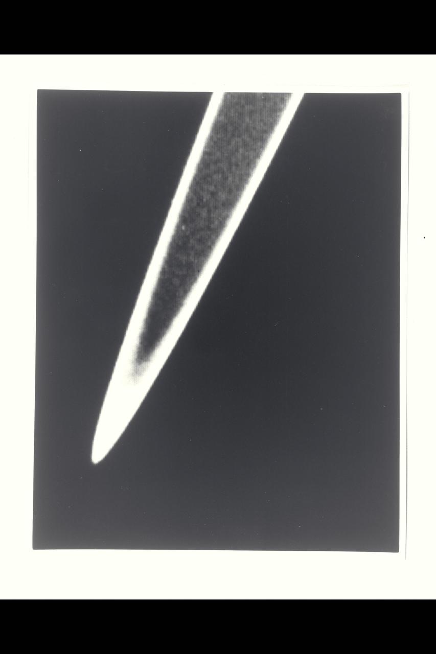 Range :   1.5 million km  ( 930,000 miles ) This high resolution view of Jupitor's ring,  part of a set obtained by Voyager 2  (A79-7101), suggests that it may be divided into several components, as are the rings of Saturn.  Seen within  the inner edge  of the brighter ring is a fainter ring, which may extend all the way down to Jupiter's cloud tops. The ring was unexpectedly bright, due to forward scattering of sunlight by small ring particles. The rings were discovered in March 1979 by Voyager 1.