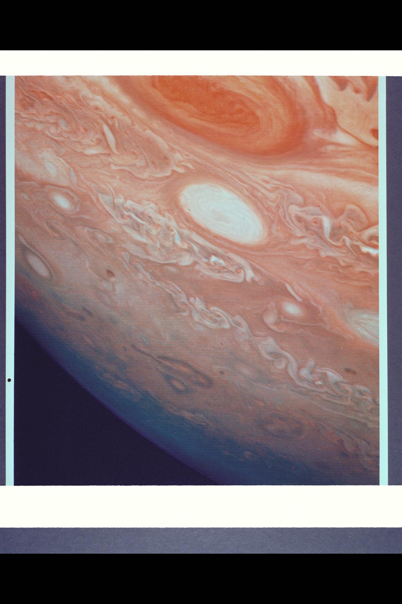 P-21737 C This picture shows a region of the southern hemisphere extending from the Great Red Spot to the south pole. The white oval is seen beneath the Great Red Spot, and several small scale spots are visible farther to the south. Some of these organized cloud spots have similiar morphologies, such as anticyclonic rotations and cyclonic regions to their west. The presence of the white oval causes the streamlines of the flow to bunch up between it and the Great Red Spot.
