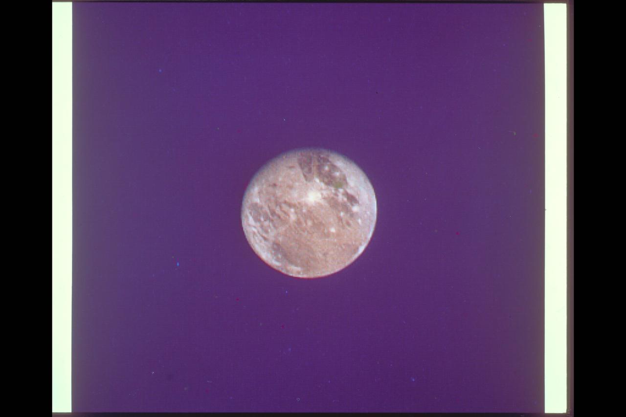 P-21749 C Range: 6 million kilometers (4 million miles) This photograph of Ganymede, the largest satellite of Jupiter, is shown at approximately the same distance as that photographed at close range by Voyager 1 in March. This picture, taken by Voyager 2, illustrates well the light, bluish regions near the north and south poles. It is known that there is exposed water ice on the surface of Ganymede, and pehaps these polar caps are composed of a light covering of water ice or frost. Voyager 2 will pass within 63,000 kilometers (39,000 miles) of Ganymede.