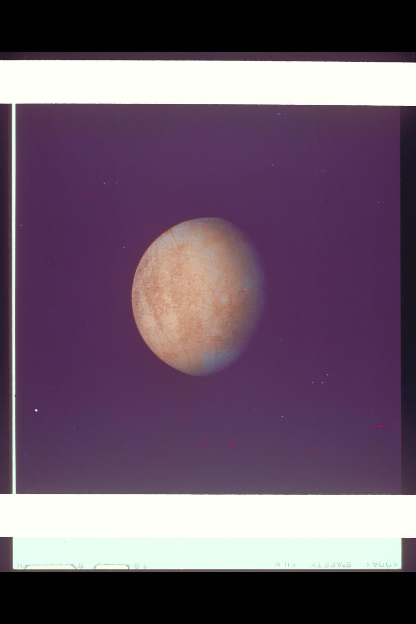 P-21752 C Range: 1.2 million kilometers This image of Europa shows detail about 20 kilometers across and is somewhat higher resolution than the best Voyager 1 image. The part of Europa shown is the hemisphere that will be viewed at even higher resolution during another Voyager 2 encounter with Europa. Color reconstruction in this image was slightly enhanced to bring out detail in the complicated mottled region on the west limb, containing some of the linear fracture-like features discovered by Voyager 1. The regions in the north and south polar areas which appear bluish in this version are in fact white.