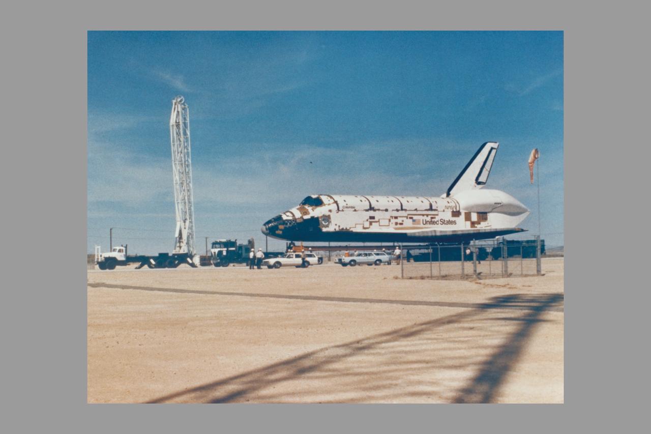 SPACE SHUTTLE ORBITER COLUMBIA 102 IS SHOWN BACKING OUT OF ITS MANUFACTURING FACILITY AT PALMDALE, CA THE ROCKWELL INTERNATIONAL SPACE DIVISION PLANT, ENROUTE TO DRYDEN FLIGHT RESEARCH CENTER. THIS ORBITER WILL BE THE FIRST SHUTTLE SPACECRAFT THAT WILL CARRY TWO ASTRONAUTS, JOHN YOUNG AND RICHARD CRIPPEN, INTO EARTH ORBITAL TEST FLIGHT IN LATE 1979.