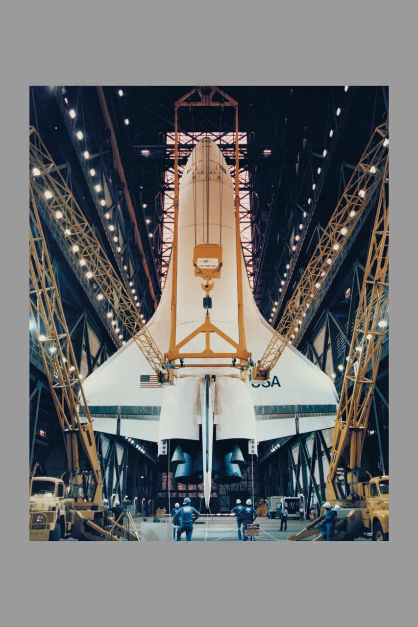 The Space Shuttle Orbiter Enterprise is lowered to the floor of the transfer aisle in the Vehicle Assembly Building during destacking operations. The Enterprise, mated to an external tank and twin inert solid rocket boosters, formed a nonlaunchable Space Shuttle which was used for fit and fuction checks of assembly, test and launch facilities at the nation's Spaceport. Enterprise will be transported to the Shuttle Landing Facility, mounted piggyback on its 747 Shuttle Carrier Aircraft, and flown to NASA's Dryden Flight Research Center, CA.