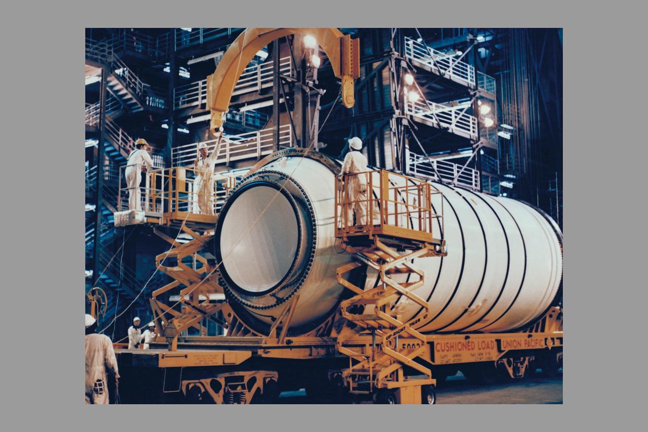 The first solid rocket booster solid motor segemnts to arrive at KSC, the left and right hand aft segments are off-loaded into High Bay 4 in the Vehicle Assembly Building and mated to their respective SRB aft skirts. The two aft assemblies will support the entire 150 foot tall solid boosters, in turn supporting the external tank and Orbiter Columbia on the Mobile Launcher Platform, for the first orbital flight test of the Space Shuttle.