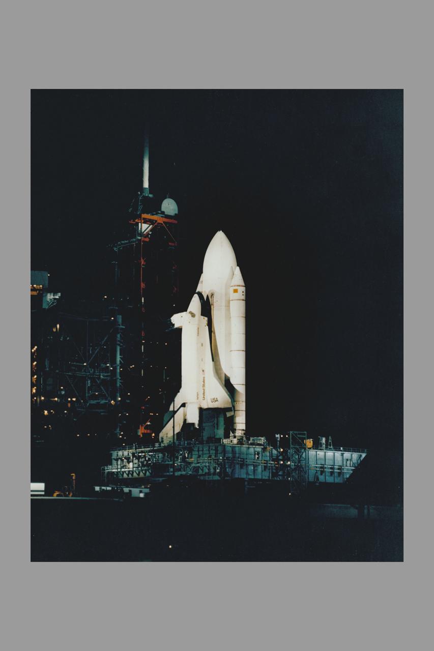 SPACE SHUTTLE ORBITER ENTERPRISE STANDS ON KSC'S PAD 39A HIGHLIGHTED AGAINST THE DARKENED FLORIDA SKY DURING TESTING OF THE HIGH-INTENSITY LIGHTING SYSTMES. THE BANKS OF XENON LIGHTS ARE USED DURING LAUCH PREPARATIONS.