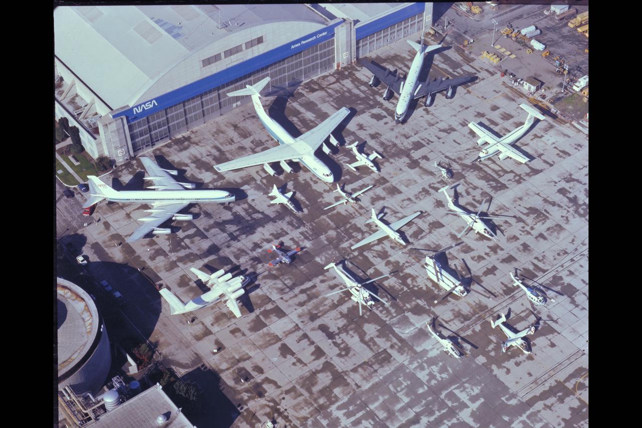 NASA Aircraft on ramp (Aerial view) Sides: (L) QSRA (R) C-8A AWJSRA - Back to Front: CV-990 (711) C-141 KAO, CV-990 (712) Galileo, T-38, YO-3A, Lear Jet, X-14, U-2, OH-6, CH-47, SH-3G, RSRA, AH-1G, XV-15, UH-1H