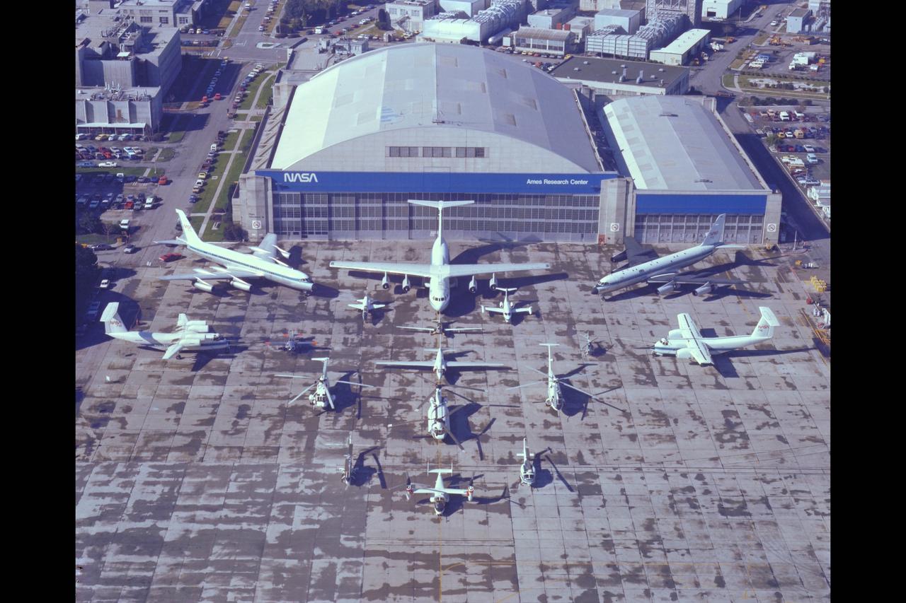 NASA Aircraft on ramp (Aerial view) Sides: (L) QSRA (R) C-8A AWJSRA - Back to Front: CV-990 (711) C-141 KAO, CV-990 (712) Galileo, T-38, YO-3A, Lear Jet, X-14, U-2, OH-6, CH-47, SH-3G, RSRA, AH-1G, XV-15, UH-1H