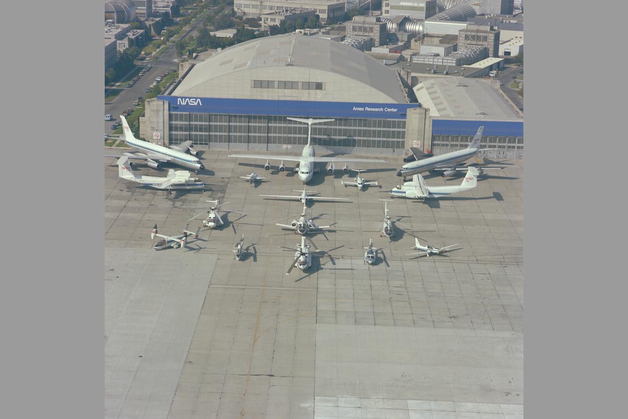 NASA Ames Research Center Aircraft and Helicopter compliment on ramp in front of Ames hangar.
