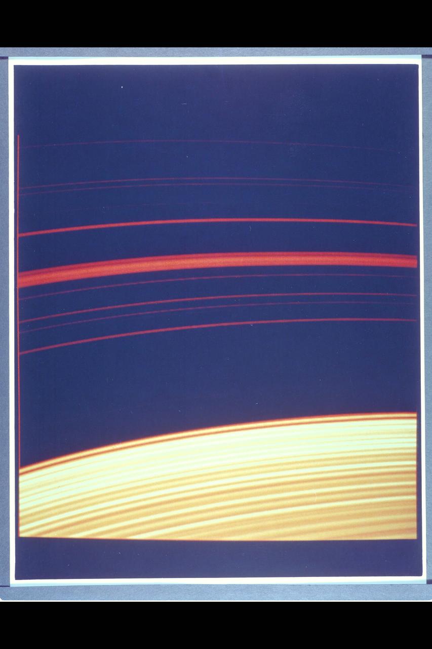 Resolution :  1 km. ( .6 miles ) Region Shown :  100 km. ( 60 miles ) P-24068C This computer generated photograph was created  from a cross-section of Saturn's rings as measured  by Voyager 2 photopolarimeter's occulation of the star Delta Scorpii. The region shown is near the inner edge of the Encke Division in the outer part of A-ring. The waves seen at left become successively closer together nearer to the Encke Division. At right are four strands of the ringlet that lies within the Encke Division. Voyager 2's imaging system saw this structure as a single ringlet.