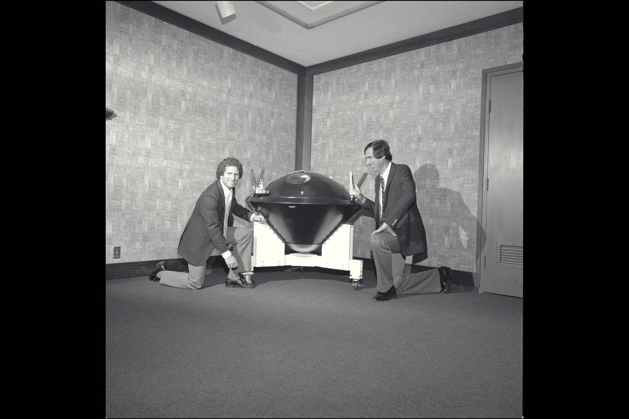 Bill Ballhaus and Nicholas Vojvodich inspect the Galileo Probe Engineering Assembly Display