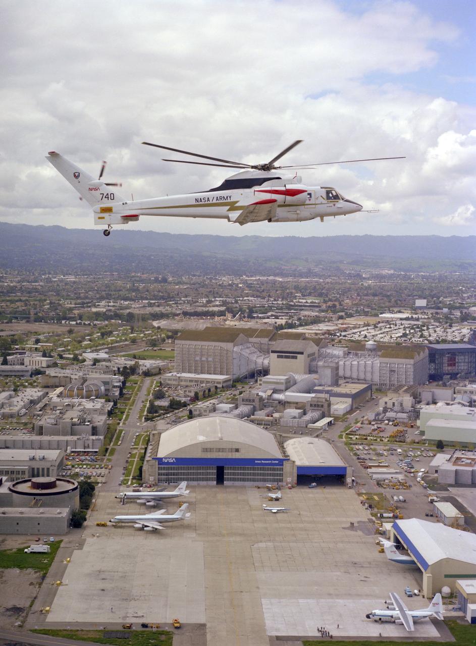 Sikorsky Rotor Systems Research Aircraft ' RSRA' (72-001 NASA-740) compound configuration in flight:  NASA Ames Research Center, Hangar and 40x 80x120ft W.T. in the background. Note:  Used in publication in Flight Research at Ames;  57 Years of Development and Validation of Aeronautical Technology NASA SP-1998-3300 fig. 132