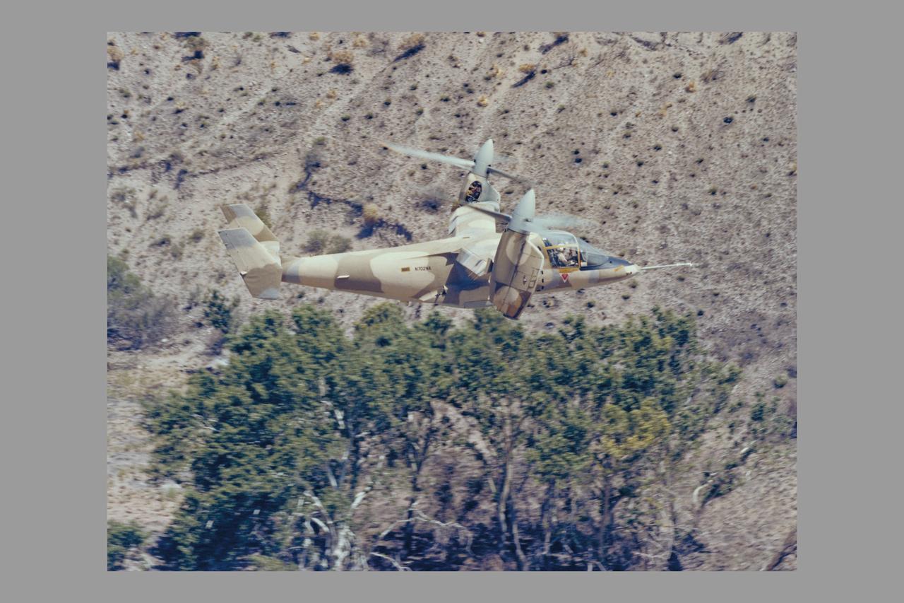 Army Camouflaged XV-15 flying NOE (nap-of-the-earth) tests (ref# 024398_