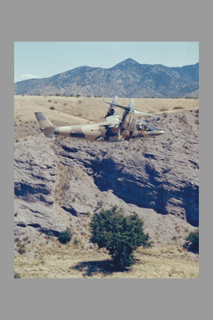 Army Camouflaged XV-15 flying NOE (nap-of-the-earth) tests (ref# 024398_