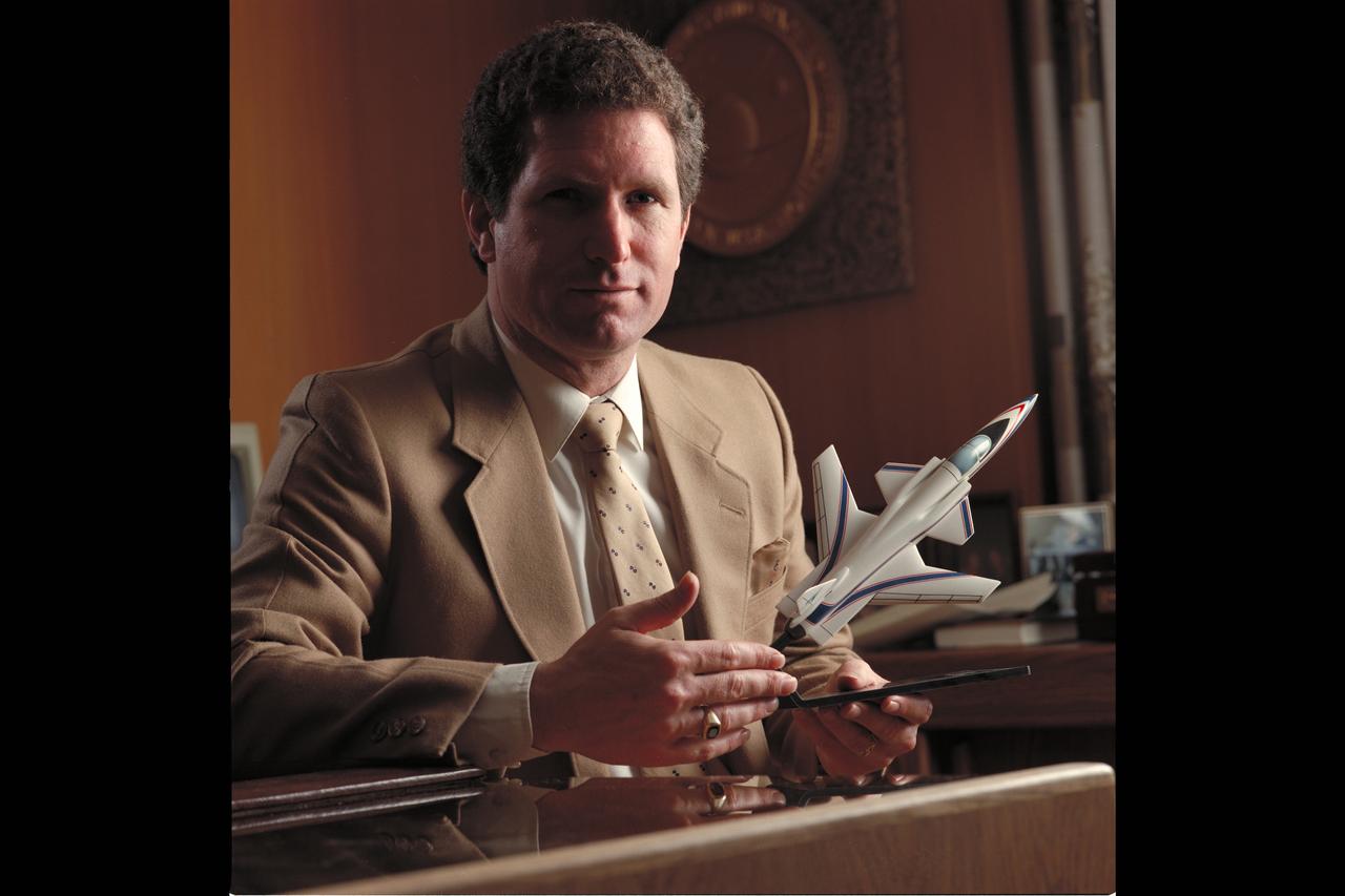 Portrait: William F Ballhaus Jr, Ames Director (1984-1989) in office holding the X-29 model