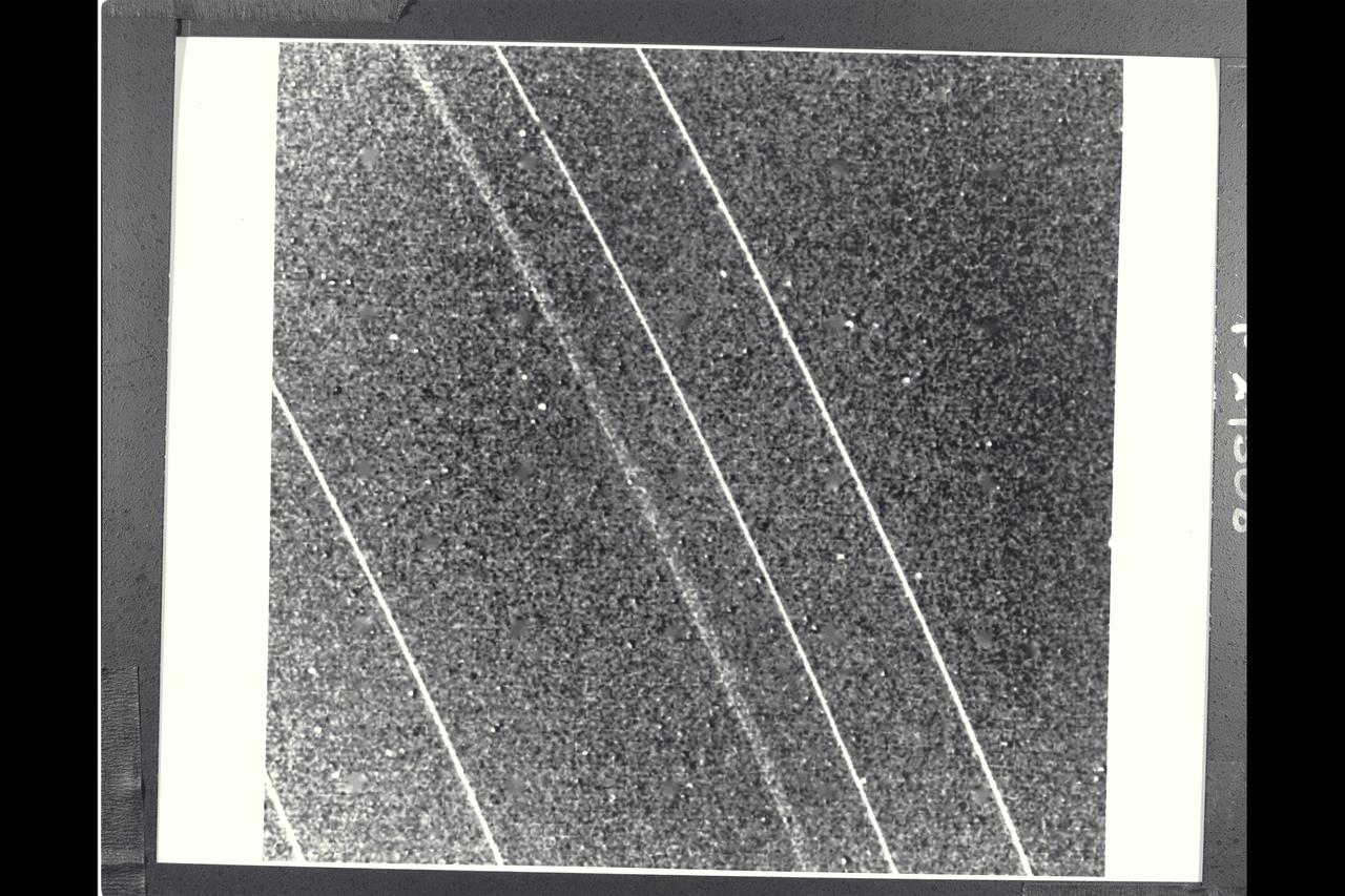 P-29508BW Range: 1.12 million kilometers (690,000 miles) This clear-filter view of the Uranian rings delta, gamma, eta, beta and alpha (from top) was taken with Voyager 2's narrow-angle camera and clearly illustrates the broad outer component and narrow inner component of the eta ring, which orbits Uranus at a radius of some 47,000 km (29,000 mi). The broad component is considerably more transparent than the dense, narrow inner eta component, as well as the other narrow rings shown. Resolution here is  about 10 km (6 mi).