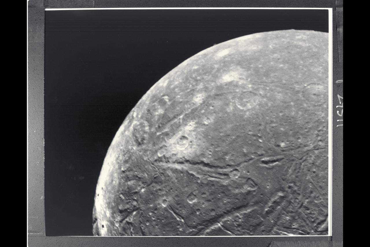 P-29511 BW Range: 130,000 kilometers (80,000 miles) This clear-filter, narrow-angle picture is part of the high-resolution Voyager 2 imaging sequence of Ariel, a moon of Uranus about 1,300 kilometers (800 miles) in diameter. The complexity of Ariels' surface indicates that a variety of geologic processes have occured. The numerous craters, for example, are indications of an old surface bombarded by meteroids over a long periond. Also conspicuous at this resolution, about 2.4 km (1.5 mi), are linear grooves (evidence of tectonic activity that has broken up the surface) and smooth patches (indicative of deposition of material).
