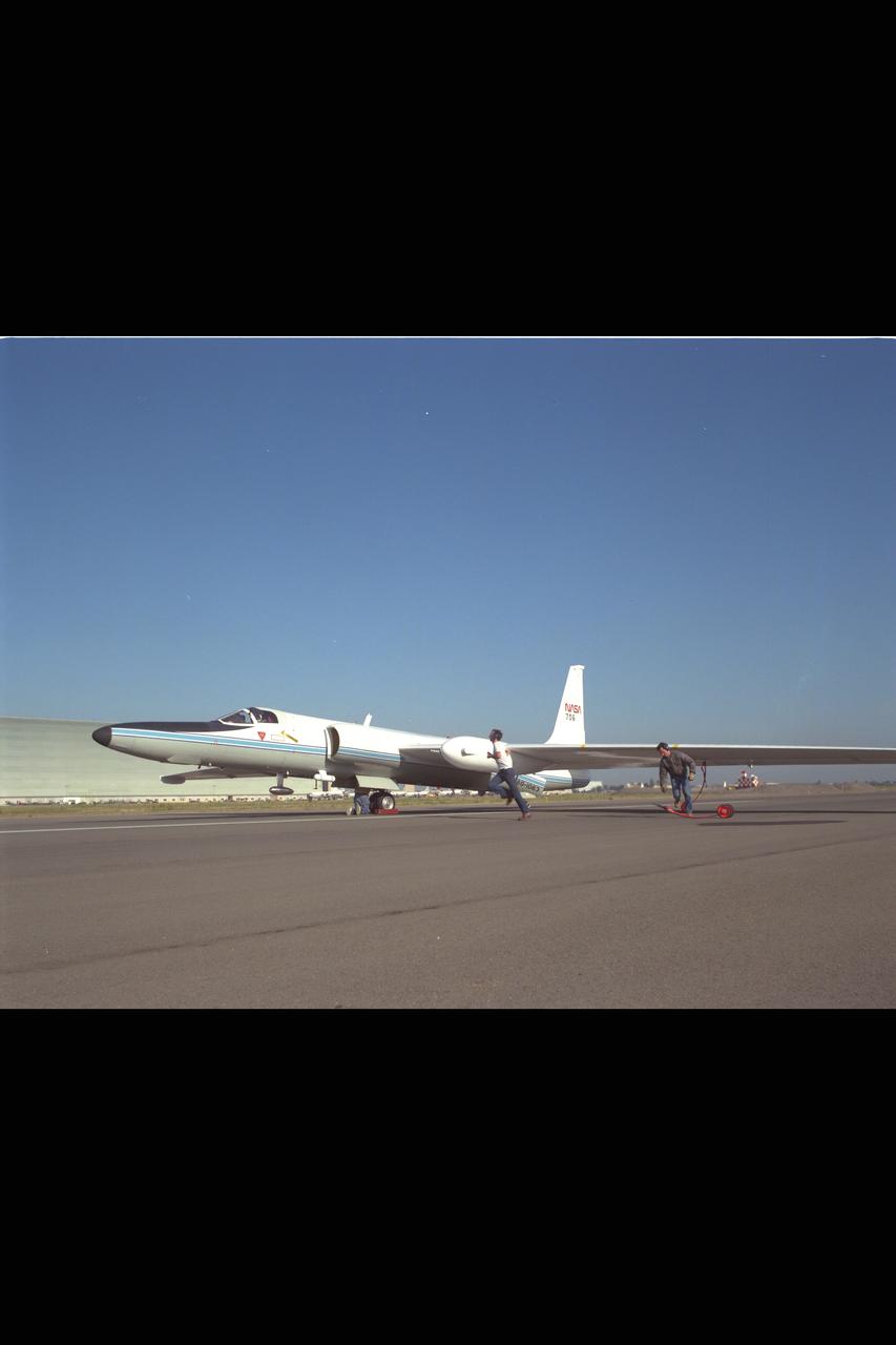 ER-2 (NASA 706) landing, image show wing wheels being placed by landing crew.