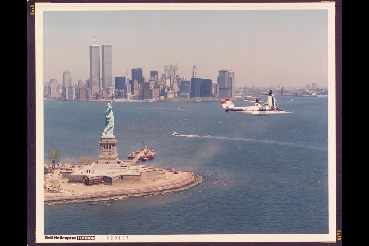 BELL HELICOPTER BELL TEXTRON XV-15 TILT ROTOR AIRCRAFT IN FLIGHT OVER NEW YORK, ELLIS ISLAND AND STATUE OF LIBERTY