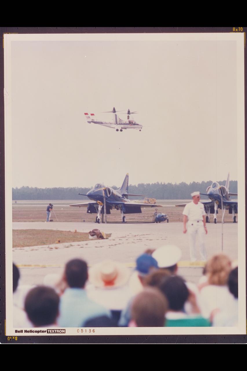 Bell Textron XV-15 Tilt Rotor Aircraft flight demo at airshow - Navy Blue Angles in forground) (Bell Helicopter Textron ref: 05136)