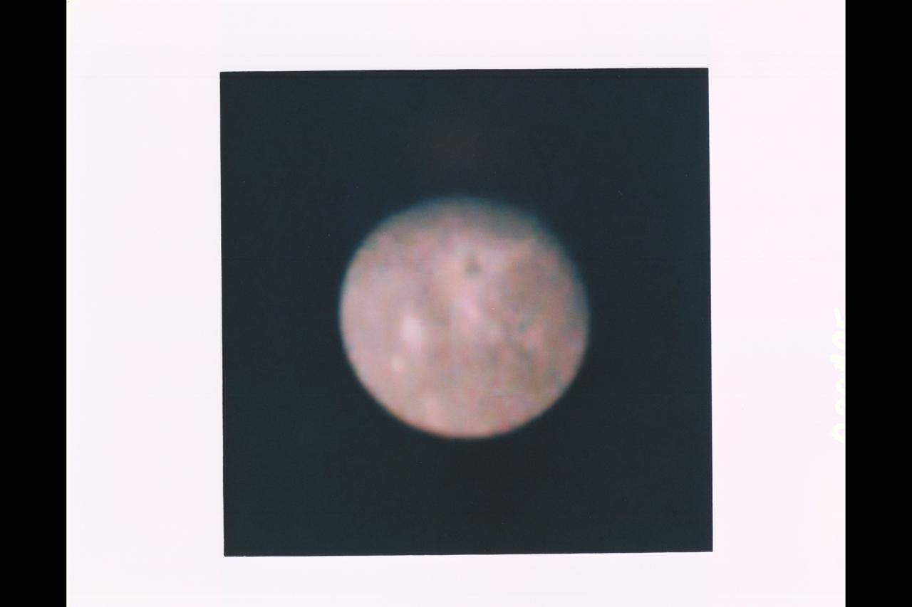 Range : 2.77 million miles (1.72 million miles) resolution : 51 km. (32 mi.) P-29495C This Voyager 2 photograph of the outermost Uranian satellite, Oberon is a computer reconstruction of three frames , exposed through the narrow angle camera's blue, green, and orange filters. the grayness or apparent lack of strong color is a distinctive characteristic of the satellites and the rings of Uranus and can serve as one indicator of the possible composition of the satellites' surfaces. Oberon has a diameter of about 1,600 km. (1,000 mi.) and orbits the planet at a radial distance of 586,000 km. (364,000 mi.). Oberon's surface displays areas of lighter and darker material, probably associated in part with impact craters formed during its long exposure to bombardment by cosmic debris. Thr resolution of this particular image is not sufficient, however, to reveal with confidece the nature of these features.