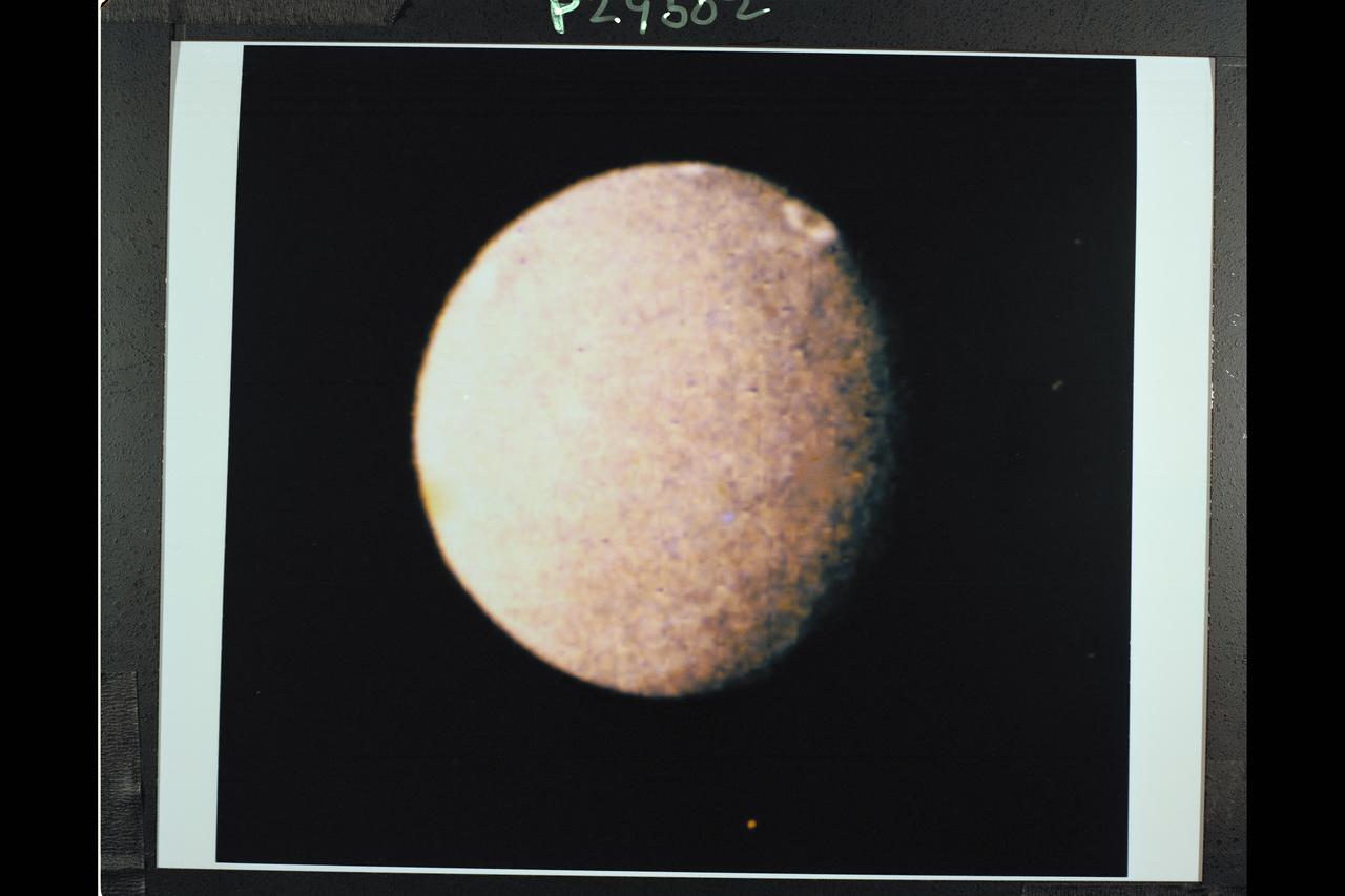 P-29502C Range: 1.04 million kilometers (650,000 miles) This color photo of Umbriel, the darkest of Uranus' five large moons was synthesized from frames exposed with the Voyager narrow-angle camera's violet and clear filters and has a resolution of 19 km (12 mi.). Umbriel is characterized by the darkest surface and smallest brightness variations of any of the large satellites of Uranus. As seen here, the surface is also generally gray and colorless. Nevertheless, at this resolution, considerable topographic detail is revealed, showing that Umbriel's surface is covered by impact craters. The brightest spot (shown at top near the equator at approxiamately 270 Â° longitude) appears as a bright ring. Its geological significance is not yet understood. Umbriel has a diameter of about 1,200 km (750 miles) and orbits 267,000 km (166,000 mi) from Uranus' center. The satellite's name, from Alexander Pope's 'Rape of the Lock,' means 'dark angel'.