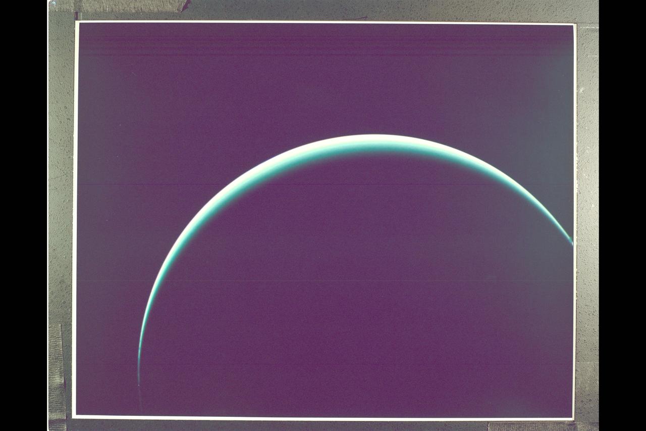 Range :  1 illion km. ( 600,000 mi. ) Resolution :  140 km. ( 90 mi. ) P-29539C This Voyager 2 image of Uranus was captured as the spacecraft was leaving Uranus behind on its cruise to Neptune. The image is a color composite of three photographs taken through blue, grren, and orange filters. Thin thin crecent seen here is at an angle of 153 degrees between the the spacecraft, the planet, and the sun. Even at this extreme angle, uranus retains the pale blue-green color seen  by the ground based astronomers and recorded by Voyager 2 during its historic encounter, this color results from the presence of methane in Uranus' atmosphere. The gas absorbs red wavelengths of light, leaving the predominant hue seen here. The tendency for the cresent to become white at the extreme edge is cased by the presence of a high-altitude haze. Voyager 2, having encountered Jupiter in 1979, Saturn in 1981, and Uranus in 1986, will proceed on its jouney to Neptune. Closest approach is scheduled for August 24, 1989.