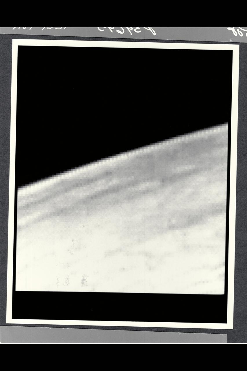 Range :  168,694 km (105,000 mi.) Voyager 2 discovered detached limb hazes in the atmosphere of Triton in Pictures that arrived at Earth between 3:30 am and 5:30 am.  The principal layer seen here begins about three km (2 miles) above the surface, and is about 3 km thick.  Fainter upward extension of the haze has been seen to an altitude of at least 14 km (9 mi.).  The haze must be comoposed of tiny particles in order to be supported in Trition's thin atmosphere.  Composition of the haze is currently unknown, but may be either condensed atmospheric gases or complex orgainc molecules produced by irradiation of the methane in Triton's atmosphere.  The vaguely linear mottling on the surface may be shadows of other haze striations.  Other features of the haze layer should be appaarent in images of Triton taken at higher phase angles (including crescent phase).  The image shows features as small as 2 km (1.2 mi) wide.